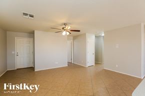 Maricopa house for rent - A spacious room with a ceiling fan and tiled flooring.