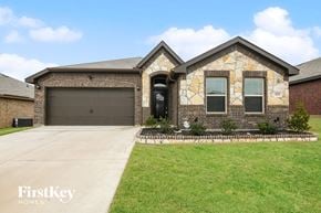 Fort Worth house for rent - a house with a driveway and a garage door