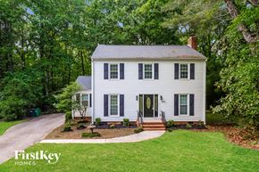 Charlotte house for rent - a white house with black shutters and a driveway