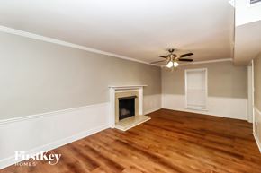 Charlotte house for rent - a living room with wood flooring and a fireplace