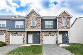 Chambersburg apartment for rent - A house with a grey and blue exterior and a stone facade.