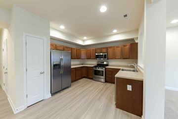 Chambersburg apartment for rent - A kitchen with wooden cabinets and a white fridge.