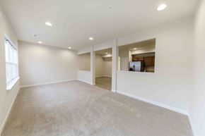 Chambersburg apartment for rent - A spacious room with a carpeted floor and a window on the left side.