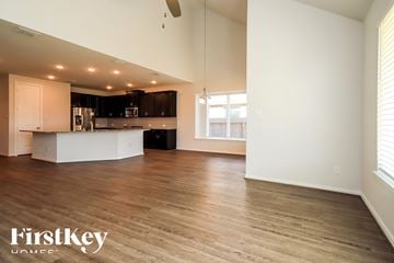Katy house for rent - A spacious kitchen and living room with wooden floors and white walls.