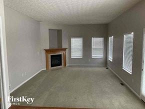 Delaware house for rent - A living room with a fireplace and a window with blinds.