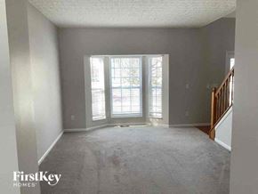 Delaware house for rent - A room with a carpeted floor and a staircase on the right side.