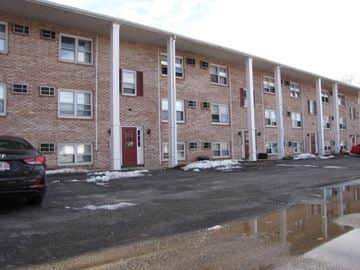 West Springfield apartment for rent - a large brick apartment building with a car parked outside