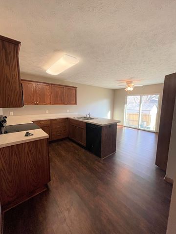 Fremont apartment for rent - A kitchen with wooden cabinets and a countertop.