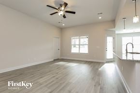 Clarksville house for rent - a clean and empty living room with a ceiling fan