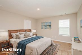 Pendergrass house for rent - A bedroom with a large bed and a painting on the wall.
