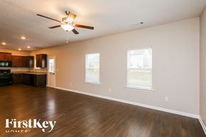 Pendergrass house for rent - A spacious room with wooden floors and a ceiling fan.