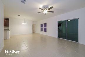 Davenport house for rent - an empty living room with a ceiling fan and a sliding glass door