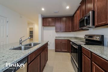 Davenport house for rent - a kitchen with granite counter tops and wooden cabinets