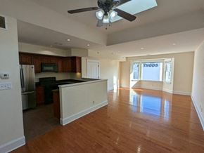 Bridgeport apartment for rent - an empty kitchen and living room with a ceiling fan