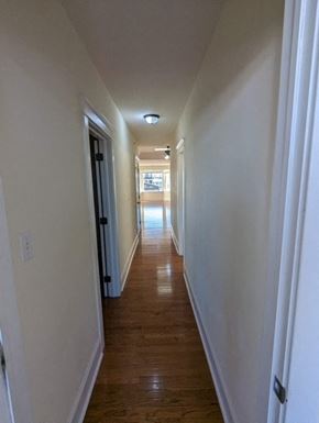 Bridgeport apartment for rent - a hallway with a wood floor and white walls