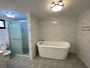 Tamuning house for rent - a bathroom with a tub and a shower and a toilet