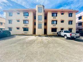 Tamuning house for rent - an apartment building with a truck parked in front of it