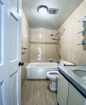 Tumon house for rent - a bathroom with a toilet and a tub and a sink
