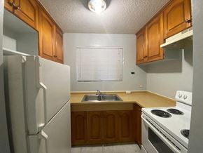 Mongmong-Toto-Maite apartment for rent - a kitchen with a stove sink and refrigerator