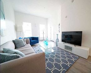 Winnipeg apartment for rent - A living room with a couch, a television, and a glass coffee table.