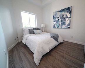 Winnipeg apartment for rent - A bedroom with a large bed and a painting on the wall.