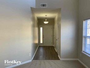 Matthews house for rent - an empty hallway with a white door and window