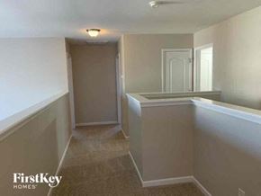 Matthews house for rent - an empty kitchen and hallway with white walls and a white door