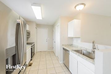 Aurora house for rent - a kitchen with white cabinets and stainless steel appliances