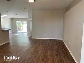 Saint Cloud house for rent - an empty living room and dining room with wood flooring