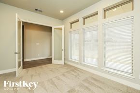 Seguin house for rent - A room with a carpeted floor and a doorway leading to another room.