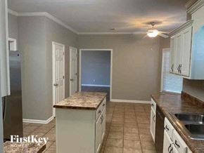 Collierville house for rent - A kitchen with a refrigerator, sink, and cabinets.