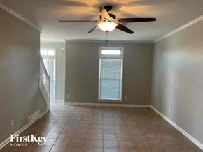 Collierville house for rent - A room with a ceiling fan and tiled floor.