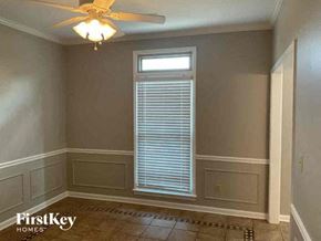 Collierville house for rent - A room with a ceiling fan and a window with blinds.