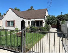 San Bernardino apartment for rent - a small white house with a metal fence