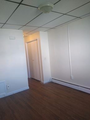 Easton apartment for rent - A room with a wooden floor and a door.