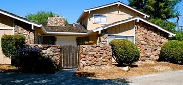 San Jose apartment for rent - a house with a fence and a stone wall
