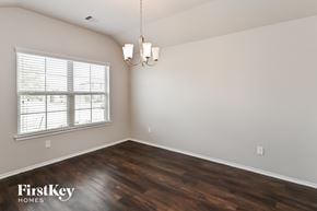 Conroe house for rent - the spacious living room with wood flooring and a large window