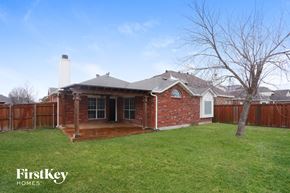 Forney house for rent - A house with a brick exterior and a white chimney is for sale.