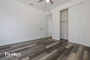 North Port house for rent - a bedroom with white walls and wood flooring and a closet
