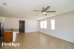 Fernandina Beach house for rent - A spacious room with a ceiling fan and a kitchenette.