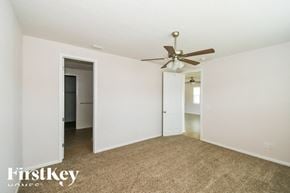 Fernandina Beach house for rent - A room with a ceiling fan and carpeted floor.