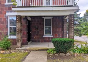 Hobart apartment for rent - the front of a brick house with the door open