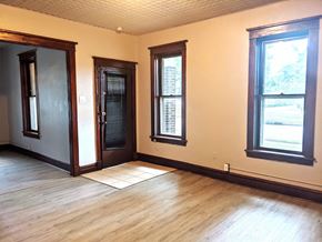 Hobart apartment for rent - a living room with wood floors and a door and windows