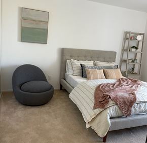 El Cerrito apartment for rent - A bedroom with a bed, chair, and a painting on the wall.