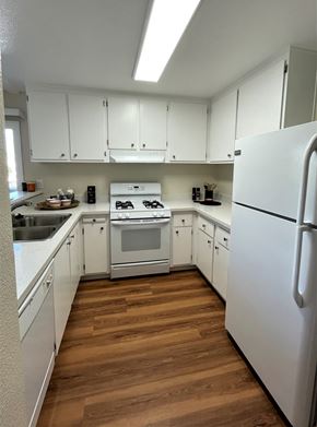 El Cerrito apartment for rent - A kitchen with white cabinets and a white fridge.