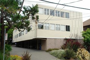 Berkeley apartment for rent - A white building with a tree in front of it.