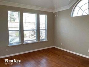 Arlington house for rent - a living room with a wood floor and three windows