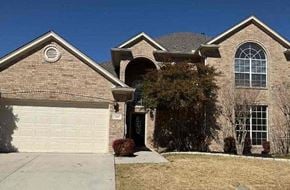 Arlington house for rent - a brick house with a white garage door