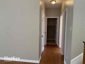 Arlington house for rent - a hallway with a wood floor and white walls