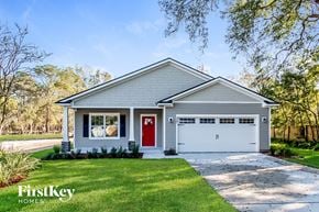 Jacksonville house for rent - A house with a red door and a garage door is shown.